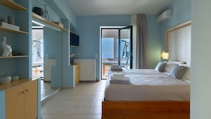 A bedroom with a bed, wooden headboard, and a view of the balcony.