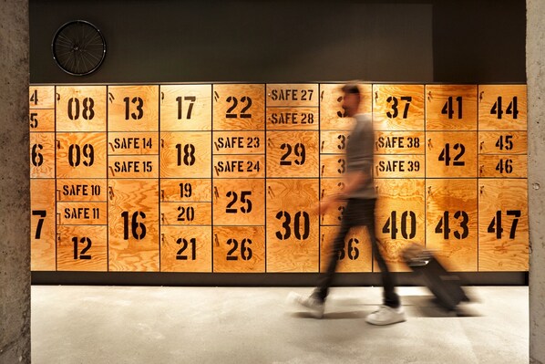 A wall with numbered lockers, some marked as "SAFE". - Stories by Grimm‘s (Münster)