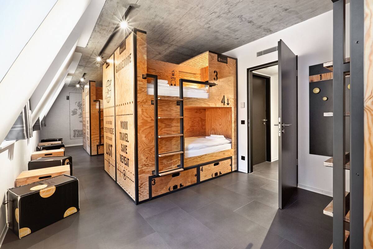 A modern loft-style bedroom with a loft bed, built-in storage, and a minimalist design.