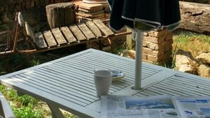 Une table avec un journal, une tasse et une plante en pot.