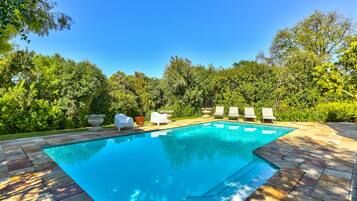 Seasonal outdoor pool, open 7:00 AM to 8:00 PM, pool loungers