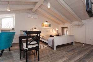 A cozy bedroom with a bed, bedside table, lamp, and a window with curtains. - Apartments and Rooms Hey Rovinj (Rovinj)