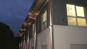 A modern building with a flat roof and multiple windows.