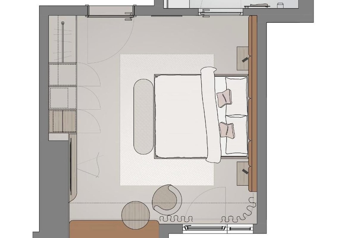 Distribución de una habitación de hotel con cama, zona de estar y baño.