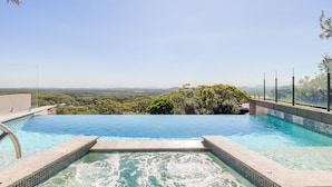 A swimming pool with a view of a forest and distant mountains. - Beach House 7,  Air Conditioned, Wi-Fi, Foxtel, Linen, Communal Pool and Spa (One Mile)