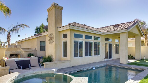 A pool area with a hot tub, outdoor seating, and a covered patio. - Country Club Home w/ Pool & Spa, 2 Mi to Coachella (Indio)
