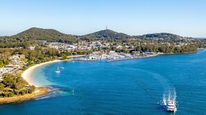 A coastal town with a marina, sandy beaches, and residential buildings.