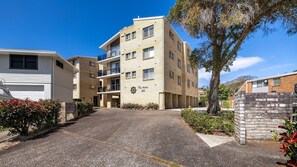 A multi-story residential building with a sign reading "The Helm 22" on the facade. - The Helm, 2/22 Voyager Cl - Stunning waterfront unit with Air Conditioning (Nelson Bay)