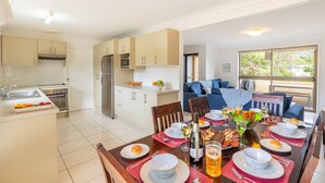 A modern kitchen with a dining area.