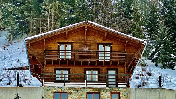 A wooden chalet with a stone base, multiple windows, and a balcony. - Chalet Le Jeuna, Morgins (Morgins)