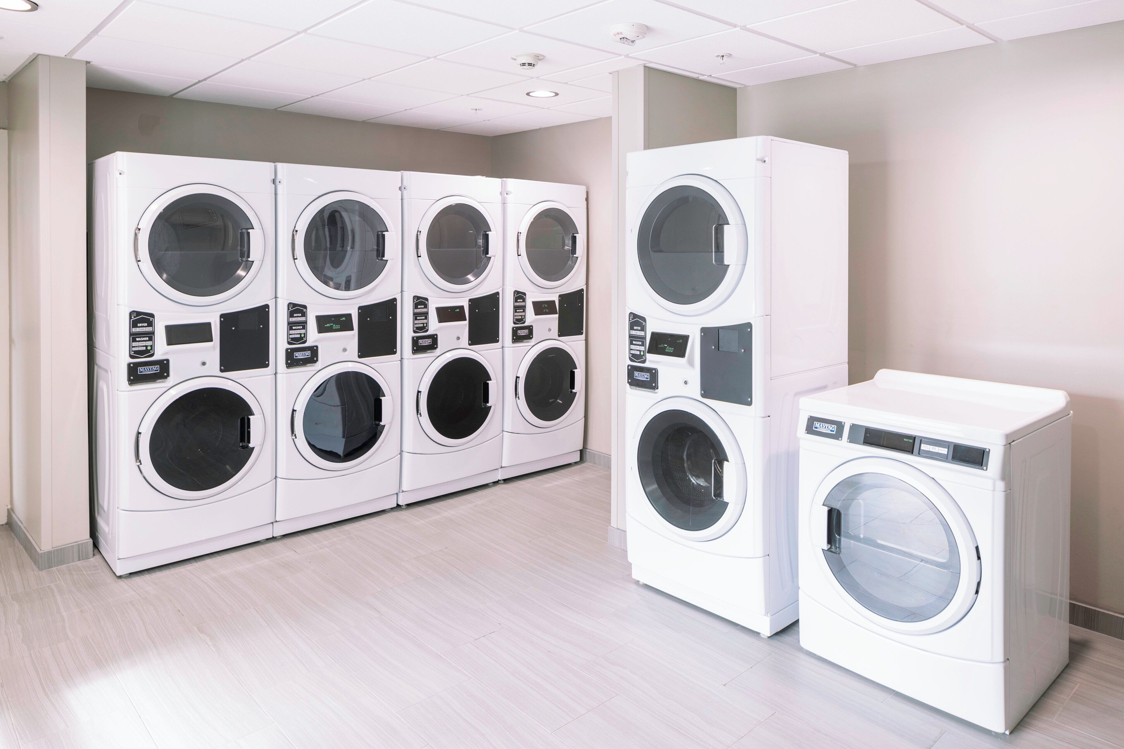 A laundry facility with multiple washing machines and dryers.