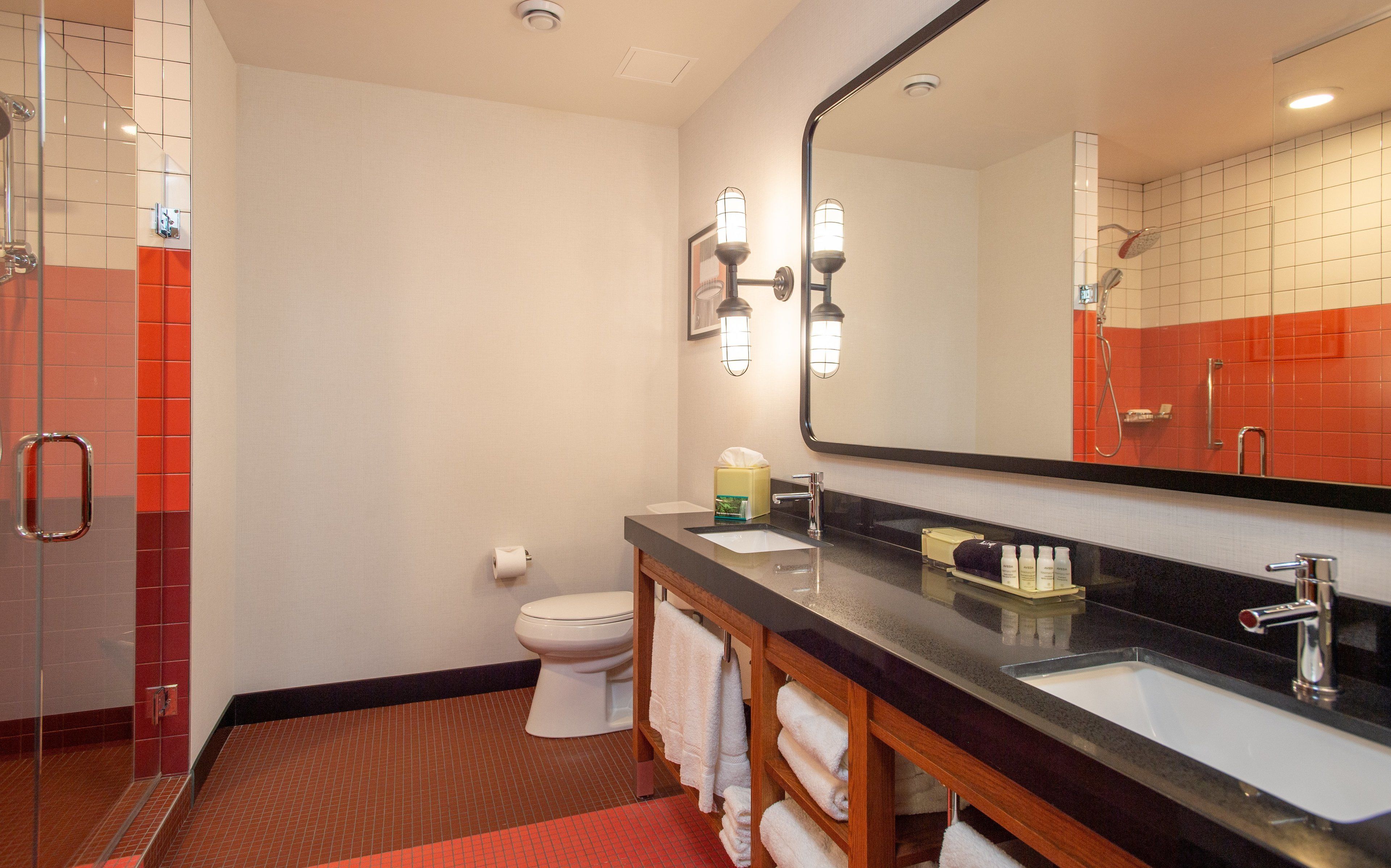suite, 1 king bed, roll-in shower (communications) | bathroom | shower, rainfall showerhead, designer toiletries, hair dryer