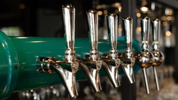 A row of beer taps with a green handle. - Hotel Indigo Madison Downtown by IHG (Madison)