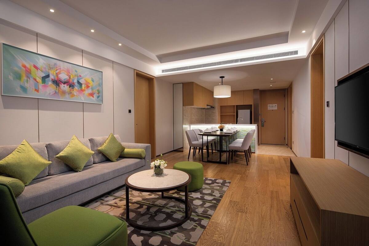 Een moderne woonkamer met een bank, een eettafel en een televisie.