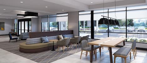 A modern interior with a seating area, a dining table, and large windows offering a view of the parking lot.