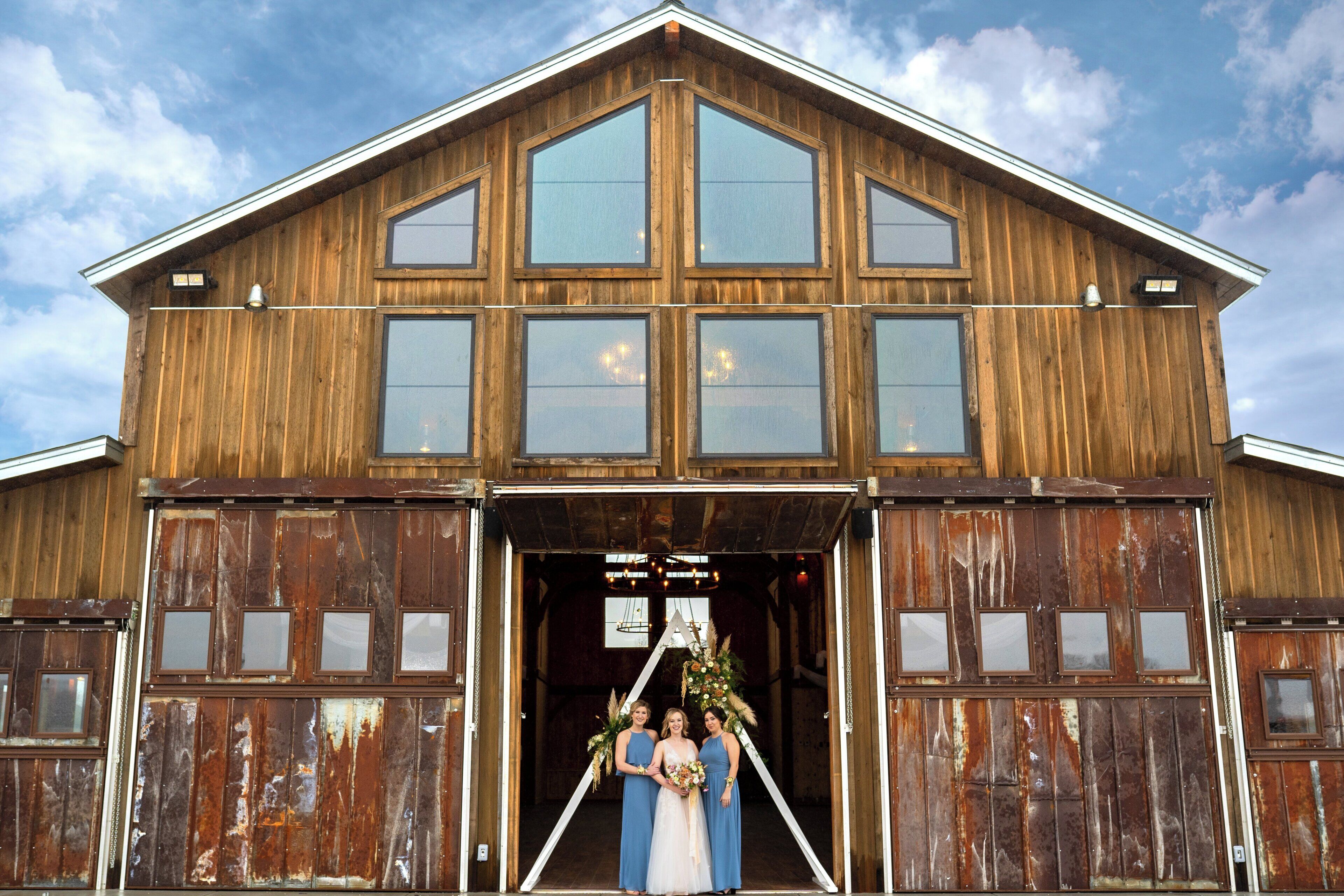 A rustic building with large windows and a gabled roof.