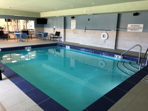 An indoor swimming pool with clear lane markings, a lifeguard chair, and a sign indicating no lifeguard on duty. - Holiday Inn Express & Suites Springfield North by IHG (Springfield)