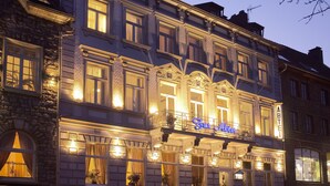 A historic building with multiple windows, a balcony, and a sign indicating it is a restaurant. - Design Hotel Zur Abtei (Aachen)