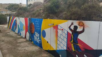 A colorful mural with a basketball player, a basketball, and the text 'IBIS BUDS GET'.