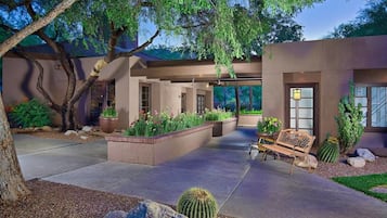 Vista frontal de la propiedad por la tarde o noche