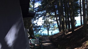 A stone pathway leading uphill, flanked by trees and a building with a sloped roof. - 8 Miles Of Sand Beach To Explore ~ Outstanding Sunrise Views Over The Lake! (Sturgeon Bay)