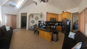 A compact living space with a kitchenette, a dining area, and a sofa. - Pet Friendly! Beach Bungalow, Peaceful, Private, 2 Bedroom, 2 Bath. (Puerto Penasco)