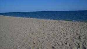 A sandy beach with a clear blue sky and calm sea. - Pet Friendly! Beach Bungalow, Peaceful, Private, 2 Bedroom, 2 Bath. (Puerto Penasco)