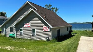 A small building with signs indicating a park for cozy cabins and lake access.