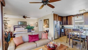 A living room with a beige sofa, a glass coffee table, and a ceiling fan. - 10TH FLOOR GULF & BEACH VIEWS | FREE WIFI | KING BED | FREE PARKING | BEACH GEAR (Bonita Springs)