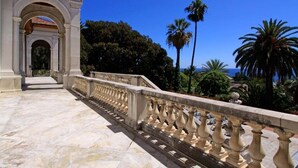 A marble pathway leading to a classical building with an arched entrance. - A Roof Between the Sky and the Sea (Sanremo)