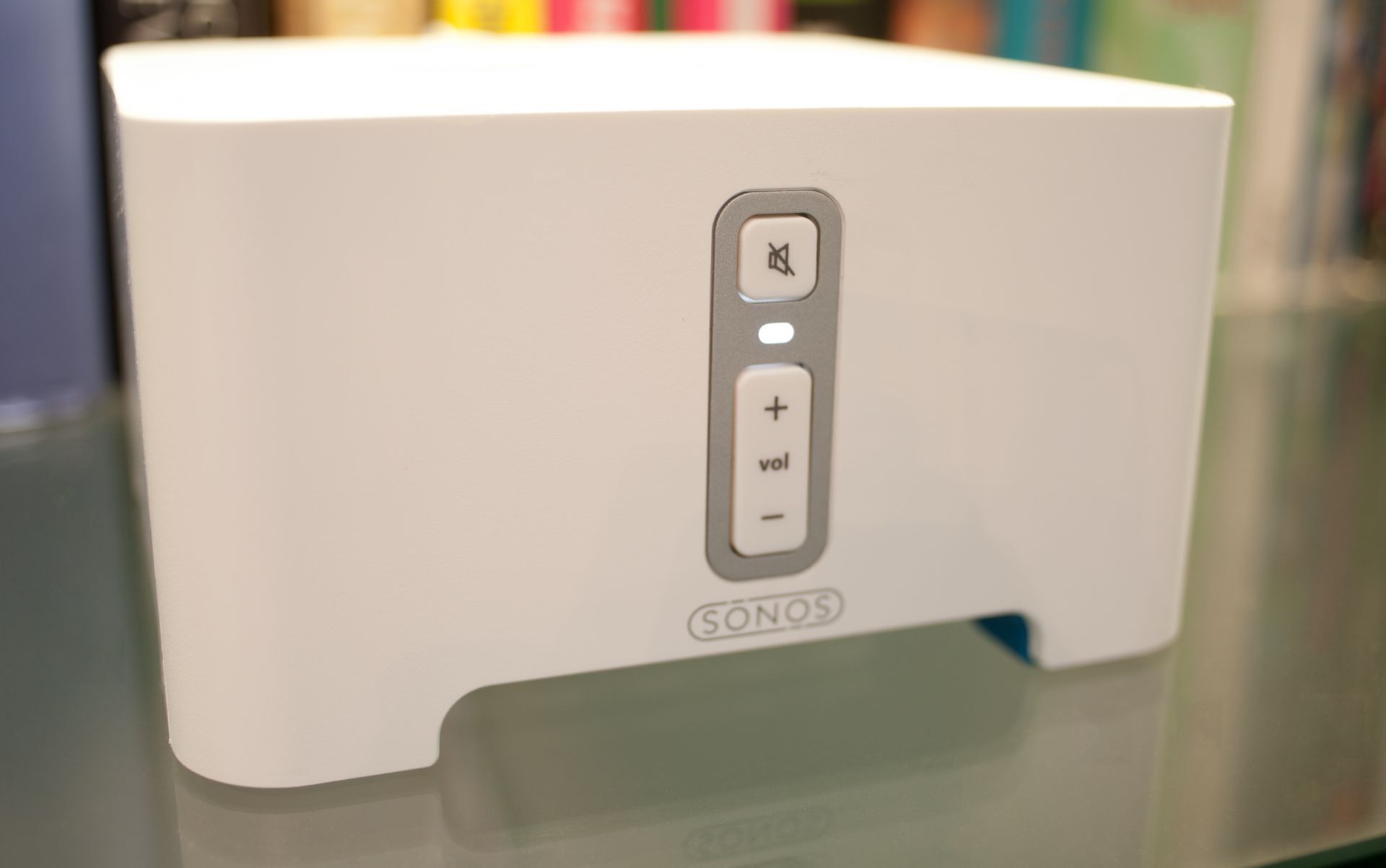 A white SONOS speaker with volume control buttons.