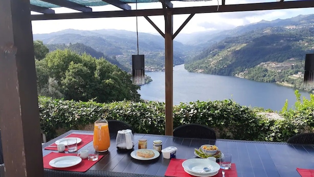 A table set for breakfast with a scenic view of a lake and mountains. - Quinta do Loureiro  Douro  Baião  Private  Pool  Stunning Views  Full privacy . (Santa Leocádia)