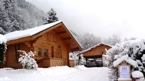 A wooden lodge with a snow-covered roof, a garage, and a sign indicating room number 351. - 538 sq ft chalet for 4 persons in Saint Gervais Mont-Blanc (Saint-Gervais-Les-Bains)