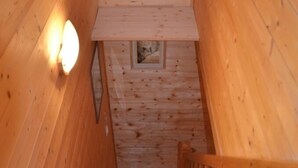 A wooden staircase with a handrail and a light fixture on the wall. - 538 sq ft chalet for 4 persons in Saint Gervais Mont-Blanc (Saint-Gervais-Les-Bains)