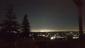 A nighttime view of a cityscape with buildings illuminated in the distance.