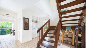 A spacious kitchen with a wooden staircase, a dining area with a view, and a balcony. - 
Kona coast studio, great rates free HS-WIFI, Parking, Walk to Magics Beach (Kailua-Kona)
