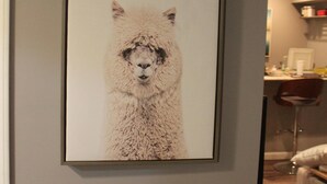 A framed artwork of an alpaca on a wall. - Luxury Apartment Close to Mayo and St. Mary s......... (Rochester)