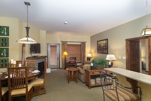 Cozy living space with a fireplace, dining area, and seating for relaxation.