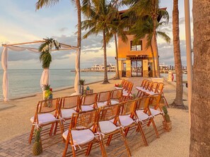A beachside wedding setup with wicker chairs and a white canopy. - Budget Friendly, Couples Welcome - Marlin Bay (Marathon)