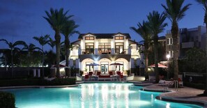 A two-story hotel with a pool, palm trees, and outdoor seating. - Home Away from Home Pet Friendly - Marlin Bay (Marathon)
