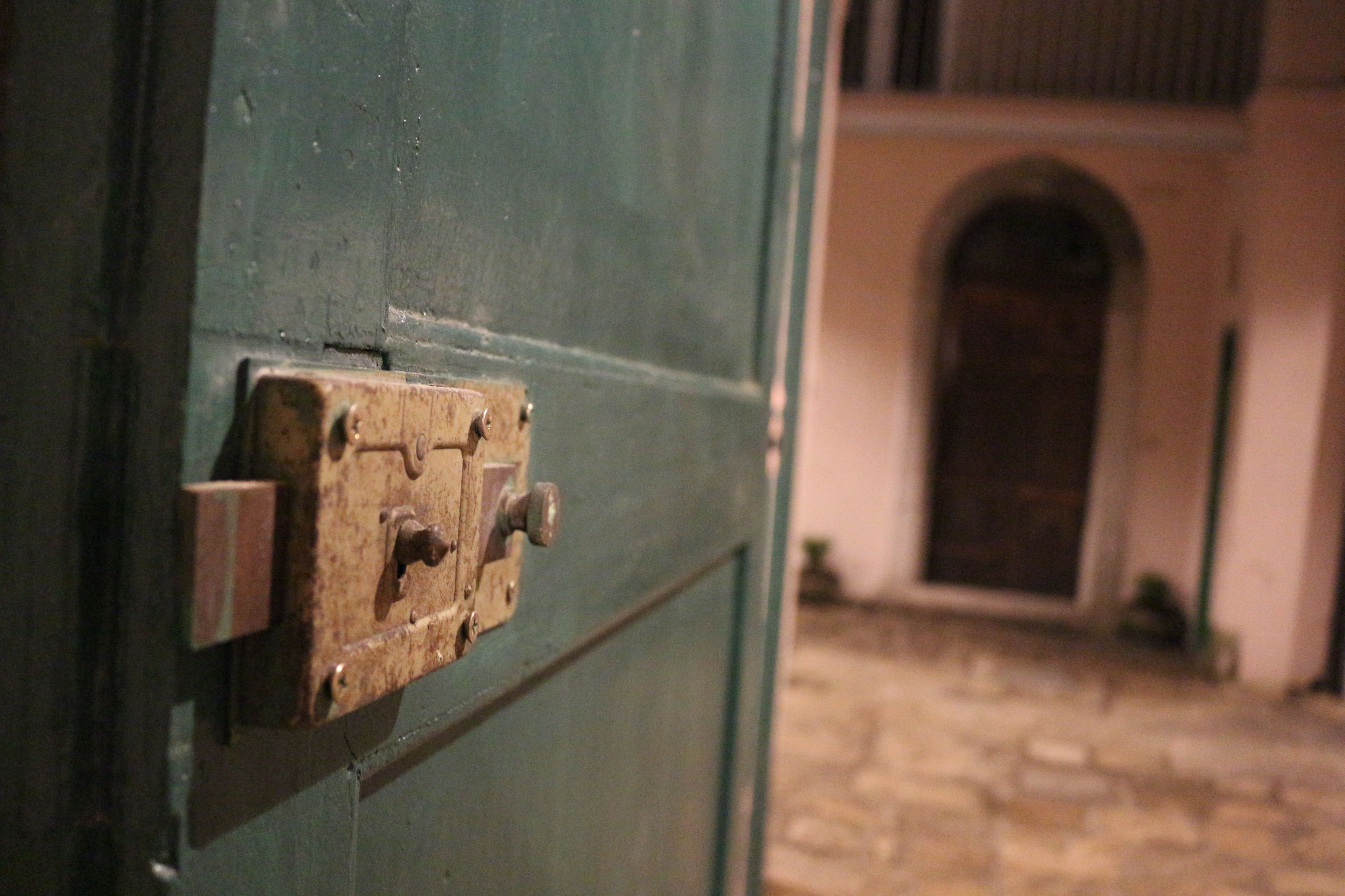 A green door with a metal latch.