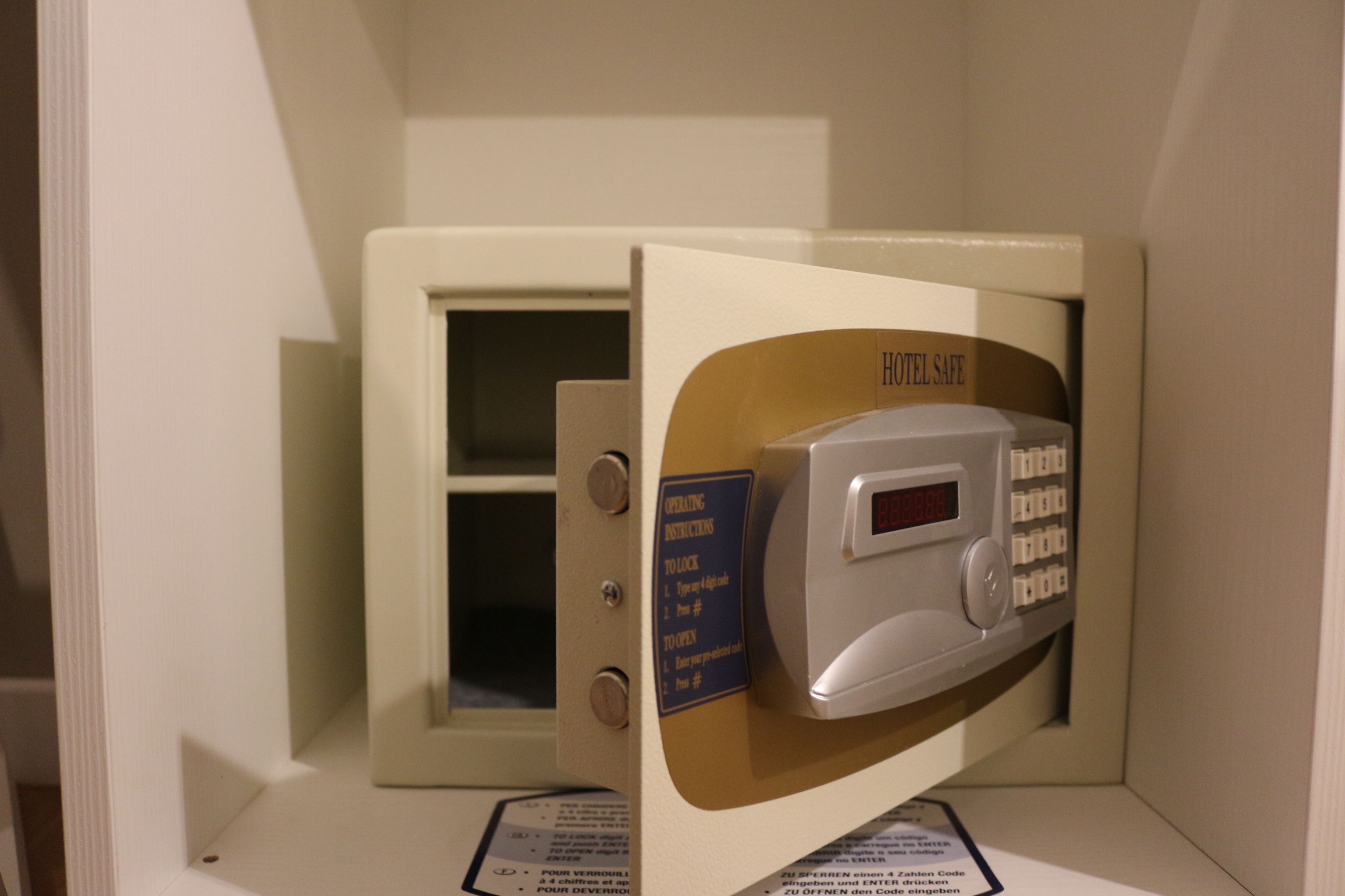 A hotel safe with operating instructions and a digital lock.