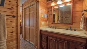 A wooden bathroom with a double sink, a large mirror, and a towel hanging on the wall. - SPECIAL RATES OCT 12-16, MT VIEWS, ATTACHED GARAGE, FLAT PAVED PARKING, PET FEE. (Maggie Valley)