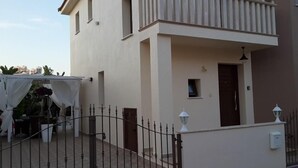 A two-story building with a balcony, a small window, and a door. - Villa With Private Pool, Sea View With Grass And 2 Gazebos (Pernera)