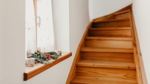 A wooden staircase with a window on the left side.