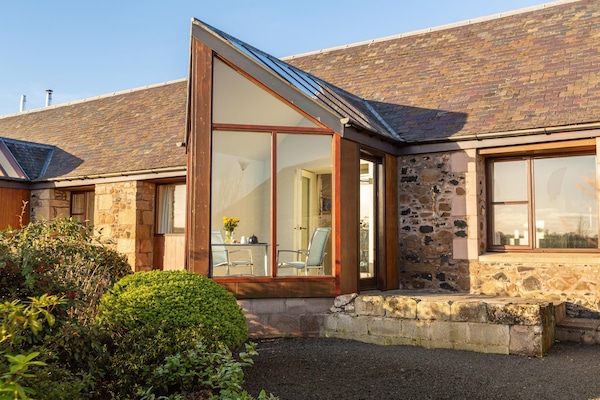 Thairn cottage has south facing conservatory overlooking cottage garden.