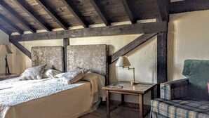 Une chambre à coucher avec un lit, une table de chevet, une lampe et une chaise.