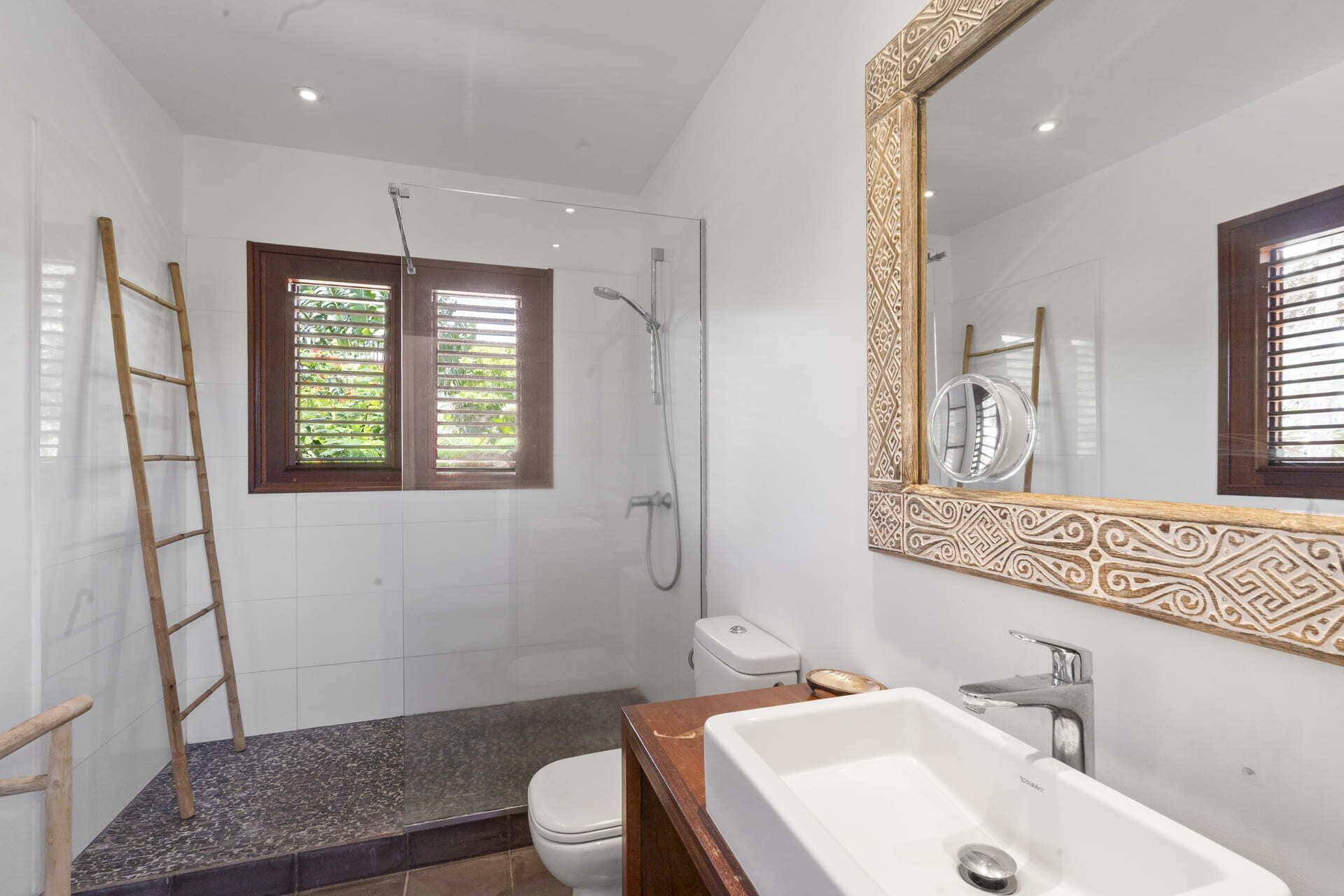 A bathroom with a shower, toilet, and sink.