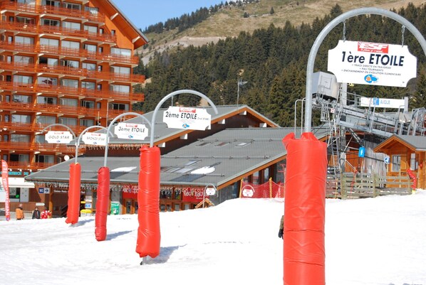 A ski resort with multiple lodges, including a 2nd star lodge, and a ski lift.