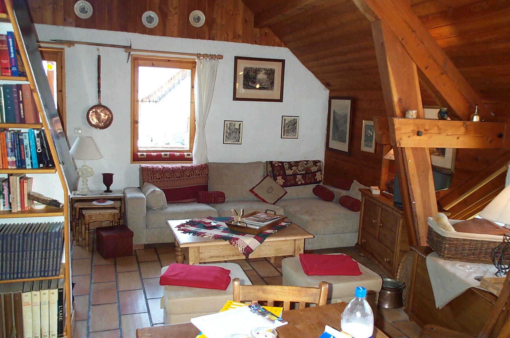 A cozy living room with a sofa, a coffee table, and a bookshelf.